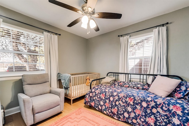 bedroom with light hardwood / wood-style flooring and ceiling fan