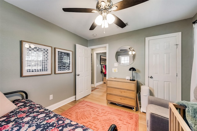 bedroom with light hardwood / wood-style flooring and ceiling fan