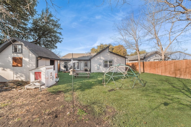 rear view of house featuring a lawn