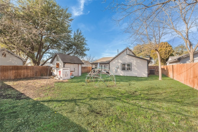 view of yard featuring a storage shed and a playground