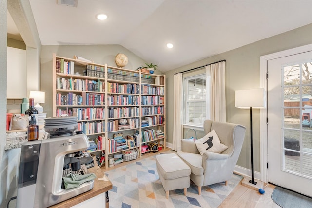 sitting room with lofted ceiling