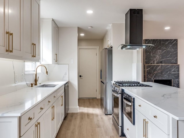 kitchen with sink, stainless steel appliances, white cabinets, and island exhaust hood