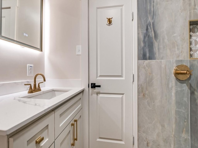 bathroom featuring vanity and a shower