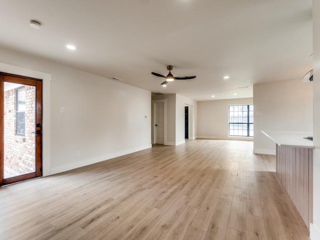 unfurnished living room with light hardwood / wood-style floors and ceiling fan