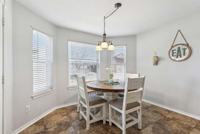 dining area featuring an inviting chandelier