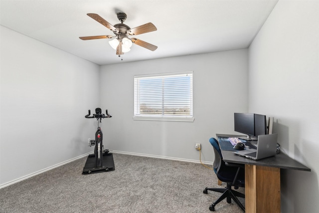 carpeted office space featuring ceiling fan