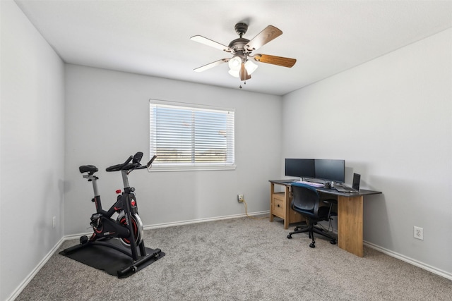 carpeted office featuring ceiling fan