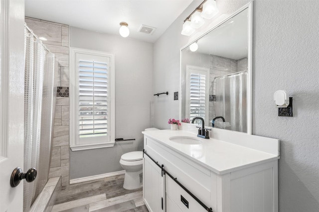 bathroom featuring vanity, hardwood / wood-style floors, a shower with curtain, and toilet