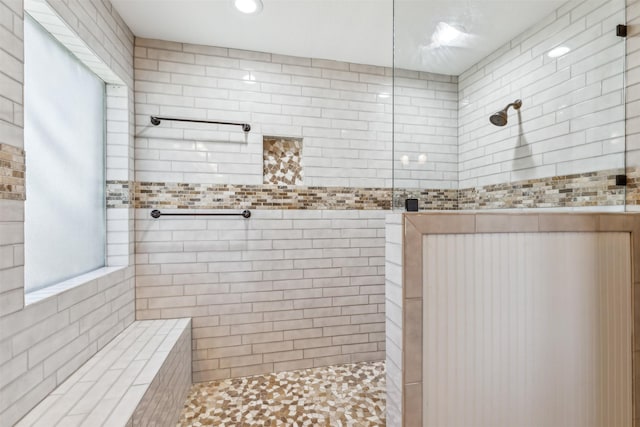 bathroom with tiled shower