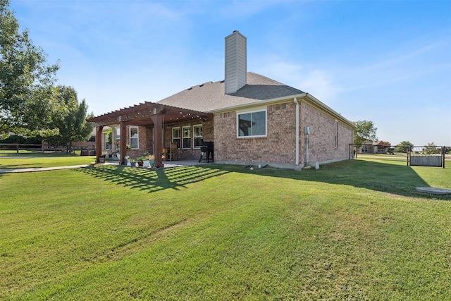 back of house featuring a pergola, a patio area, and a lawn