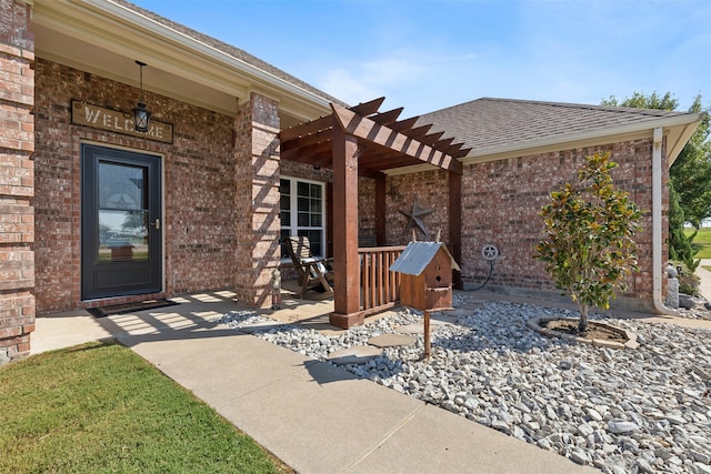 property entrance with a pergola and a patio