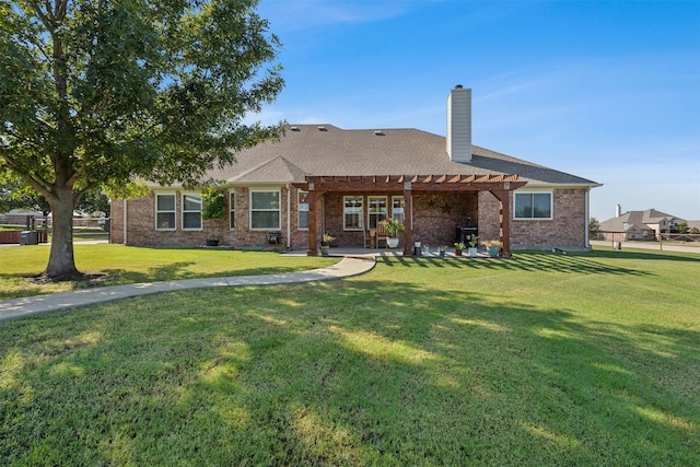 back of property with a yard and a pergola