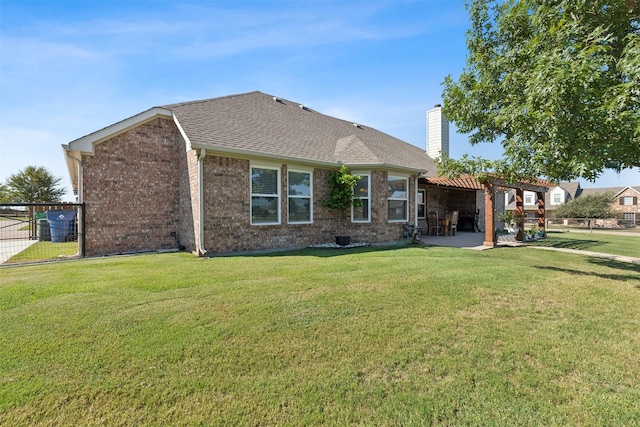 back of property featuring a yard, a patio area, and a pergola