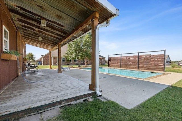 view of pool featuring a wooden deck and a lawn