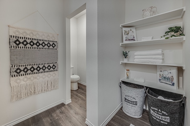 bathroom featuring hardwood / wood-style floors and toilet