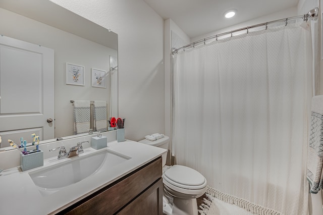 bathroom with vanity, a shower with shower curtain, and toilet