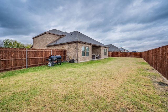 back of property featuring a yard and cooling unit