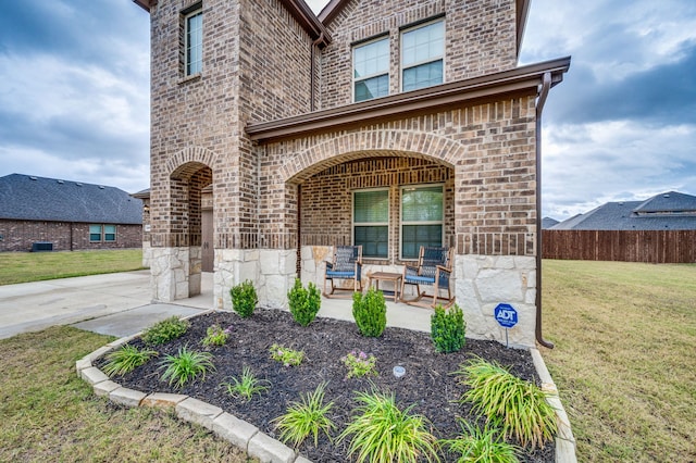 view of exterior entry with a lawn