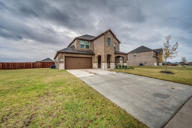 view of front of home with central AC and a front yard