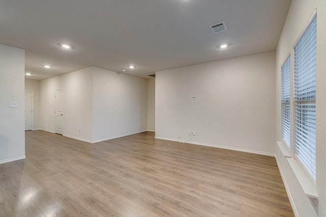 unfurnished room with light wood-type flooring