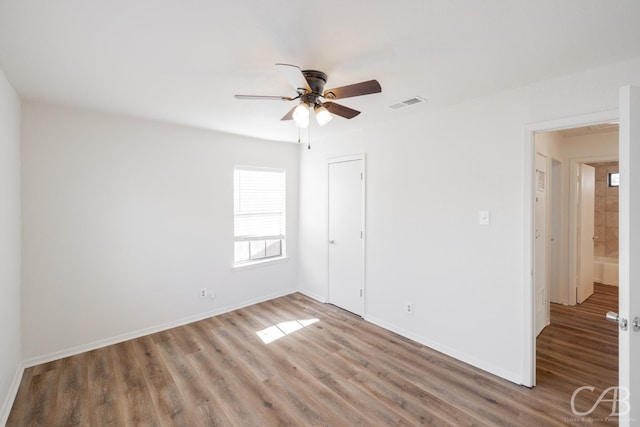 unfurnished room with ceiling fan and wood-type flooring