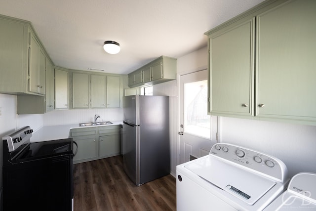 washroom with independent washer and dryer, dark hardwood / wood-style floors, and sink