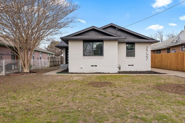 rear view of house with a lawn