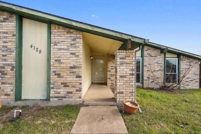 entrance to property with a lawn