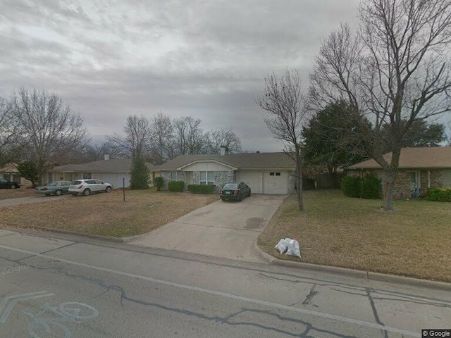 single story home featuring a garage and a front yard