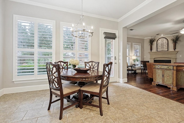 dining area with hardwood / wood-style floors, crown molding, and ceiling fan with notable chandelier