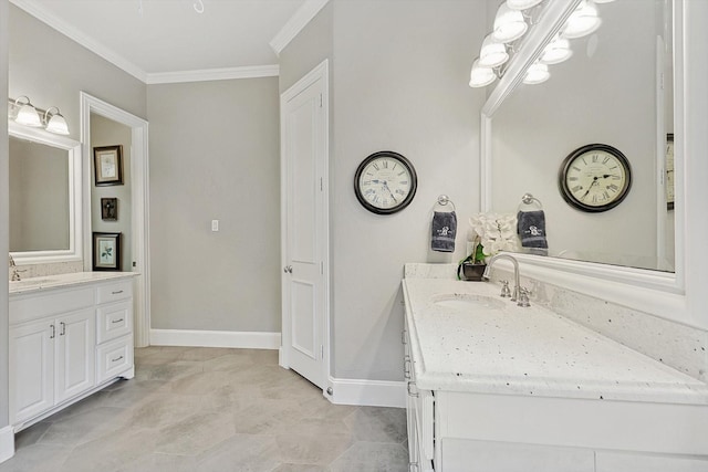 bathroom with ornamental molding and vanity