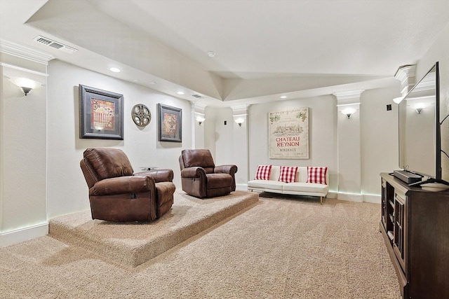 carpeted living room featuring decorative columns