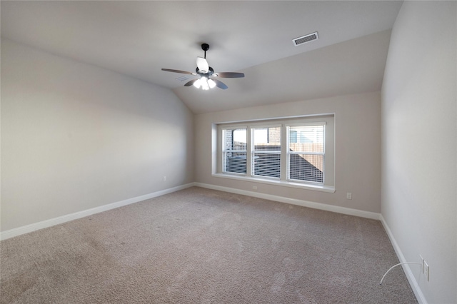 carpeted empty room featuring ceiling fan and lofted ceiling