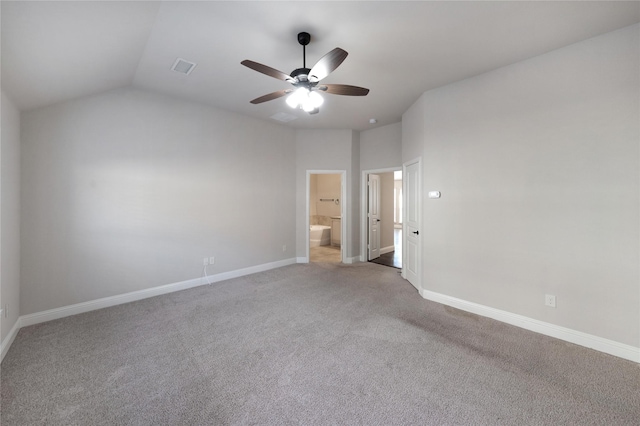 unfurnished bedroom featuring ceiling fan, carpet flooring, vaulted ceiling, and ensuite bath