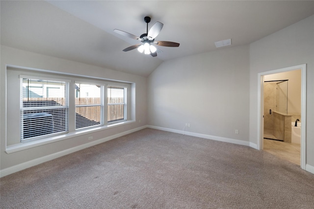 carpeted empty room with ceiling fan and lofted ceiling