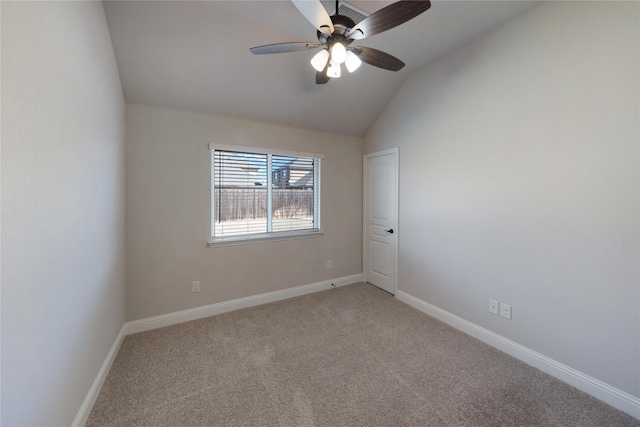 carpeted empty room with vaulted ceiling and ceiling fan