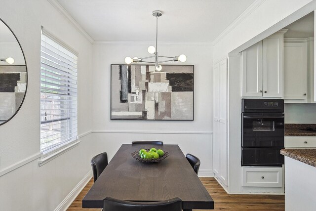 dining area with an inviting chandelier, ornamental molding, dark hardwood / wood-style flooring, and a wealth of natural light