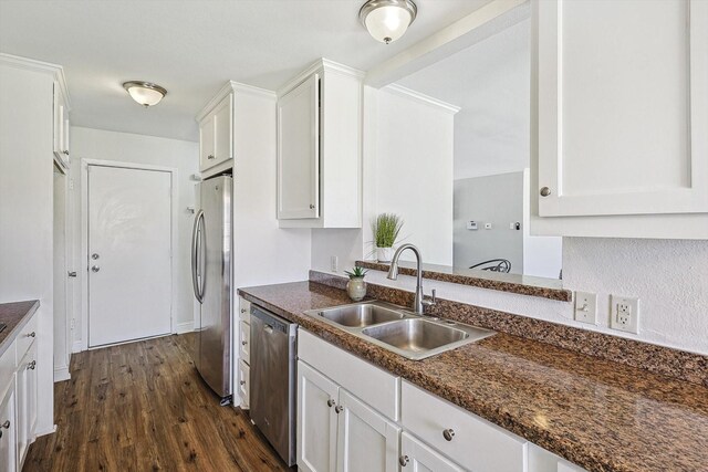 kitchen with white cabinetry, appliances with stainless steel finishes, dark stone countertops, and light wood-type flooring