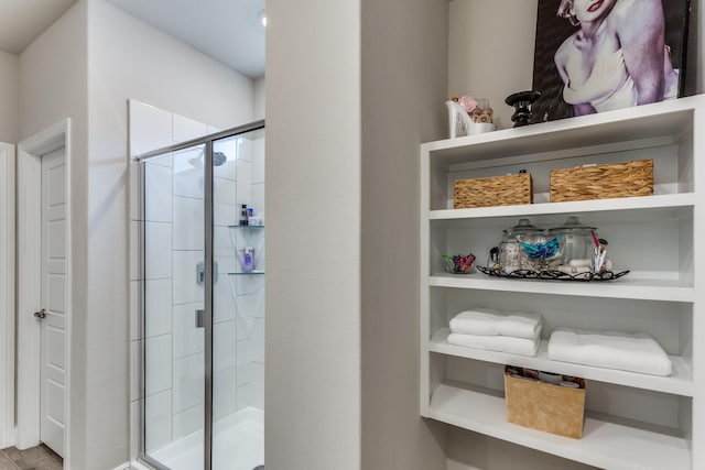 bathroom featuring a shower with door