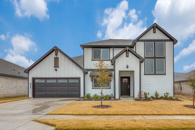 modern farmhouse featuring a garage and a front yard