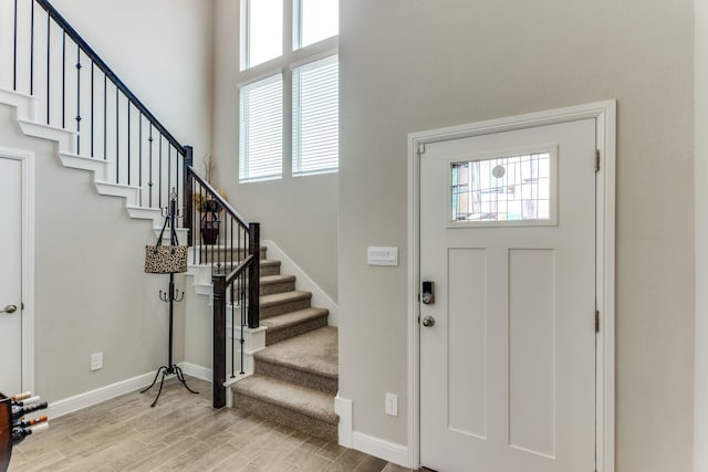 entrance foyer featuring a high ceiling and light wood-type flooring