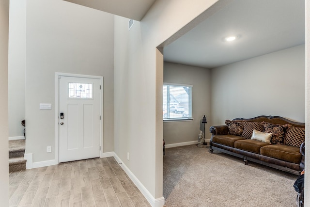 foyer entrance with light hardwood / wood-style floors