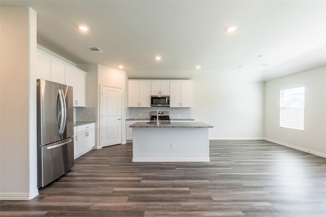 kitchen featuring white cabinetry, sink, stainless steel appliances, and a center island with sink