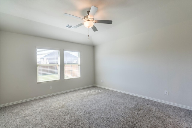 spare room featuring vaulted ceiling, ceiling fan, and carpet