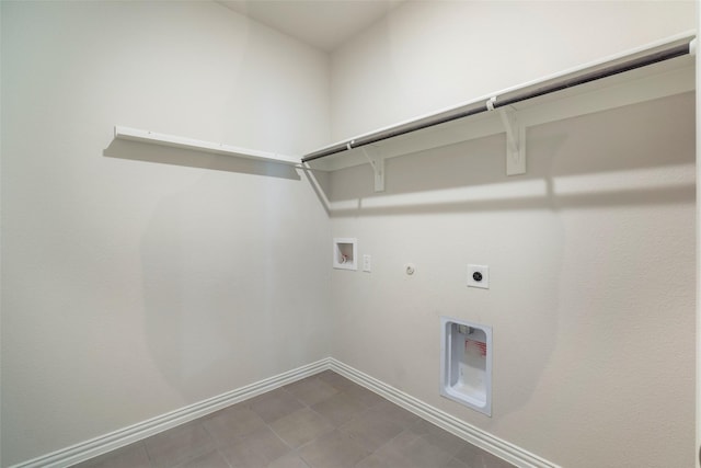 laundry area with laundry area, baseboards, gas dryer hookup, hookup for an electric dryer, and washer hookup