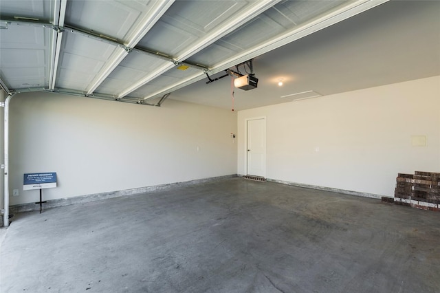 garage with baseboards and a garage door opener