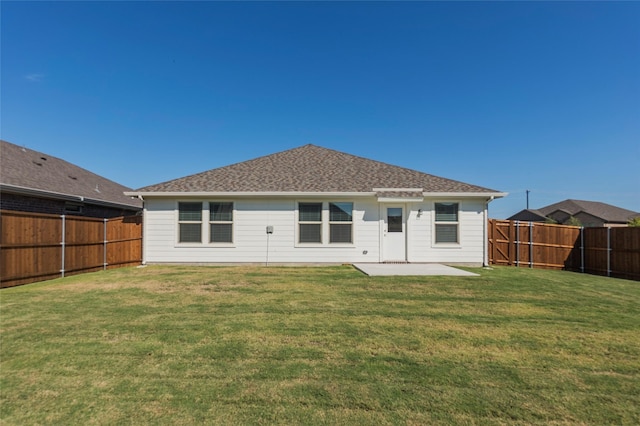 back of property featuring a patio area, a fenced backyard, a yard, and roof with shingles