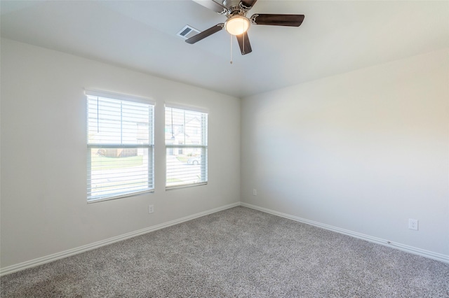 carpeted spare room with ceiling fan