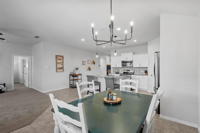 dining space featuring light tile patterned floors, a notable chandelier, light carpet, recessed lighting, and baseboards