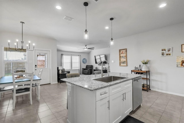 kitchen with a center island with sink, visible vents, hanging light fixtures, a sink, and dishwasher